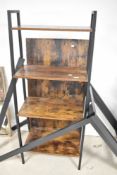 A rustic style laminate ladder bookshelf with desk attachment