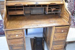 An early 20th Century oak roll top desk, width approx. 120cm