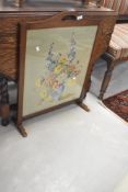 An oak framed tapestry firescreen