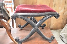 A Victorian ebonised stool having X frame , width approx. 50cm