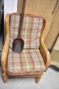 A wicker armchair with tweed style cushions