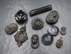 A selection of jet mourning jewellery including brooches and pendants, a pendant/brooch with hair