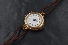 A 9ct gold cased wristwatch, the circular white dial having Arabic numerals, the case marked 375, on