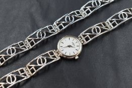 A silver cased Rotary wristwatch, the white dial having baton numerals, on a white metal pierced