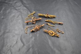 Five yellow metal bar brooches, all stamped 9ct and of various designs, some damage, approx 8.7g