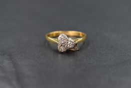 A 22ct gold diamond trio ring having three small diamonds in a cushion mount modelled as a three