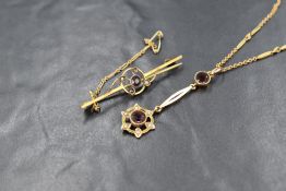 A rose metal fancy link chain stamped 9ct having barrel clasp and amethyst and seed pearl pendant