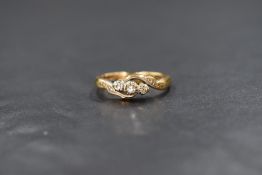 An 18ct gold diamond chip set trilogy ring, the three graduated illusion set diamond chips in a