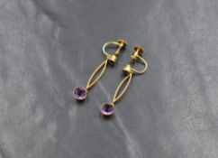 A pair of yellow metal screw back earrings stamped 9ct having amethyst studs with lozenge connectors
