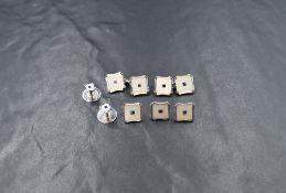 A cased set of 9ct white gold mother-of-pearl and sapphire set cufflinks and collar pins, of concave