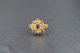 A Victorian 15ct gold sapphire and seed pearl ring, the central old cut sapphire surrounded by
