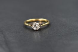 A yellow metal diamond solitaire ring having an old cut diamond of approx 0.75ct in a claw set mount