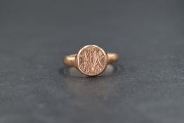 An early 20th century 9ct rose gold signet ring having monogrammed circular cartouche, size O &