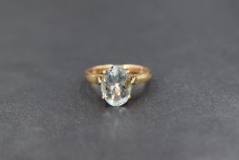A yellow metal presumed gold aquamarine solitaire ring, the oval cut aquamarine measuring