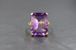An 18ct gold amethyst set ring, the large emerald cut amethyst measuring approximately 17.7mm x 13mm