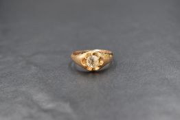 A 9ct gold gypsy style ring, the central clear stone in a six claw closed back setting, marked