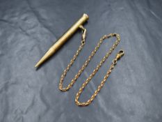 A 9ct gold mechanical pencil, on a 9ct gold mariners chain with dog clips, both marked 375, 34.1g
