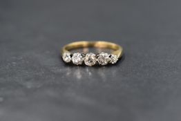 An 18ct gold diamond set five stone ring, the graduated old cut diamonds measuring approximately 0.