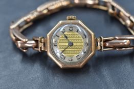 A 9ct gold cased vintage wristwatch, the champagne dial having Arabic numerals and a central