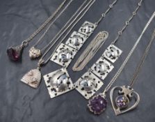 Five silver pendants with chains, including bee hive, Merano glass, woven heart and rough mined