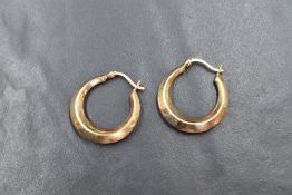 A pair of 9ct gold hoop earrings, the hoops of plain form with hinge post closures, marked 375, 2.