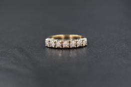 A 9ct gold seven stone diamond half eternity ring, having seven 0.32ct diamonds in illusionary
