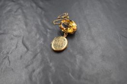 A yellow metal oval citrine brooch, the large oval cut stone measuring approx 25mm x 20mm in a