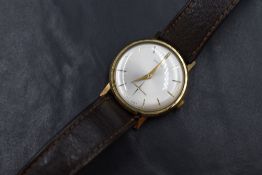 A gent's 9ct gold mechanical wrist watch by Garrard having a baton numeral dial with subsidiary