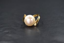 A 14ct gold pearl set dress ring, the cultured pearl having a white lustre measuring approximately