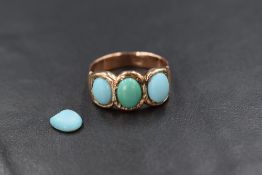 A 9ct rose gold turquoise trio ring having three oval turquoise cabochons (central stone replaced)