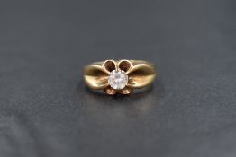 A 9ct gold gemstone set gypsy ring, the round cut clear gemstone possibly topaz or spinel in a six