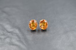 A pair of 9ct gold oval citrine stud earrings having claw set mounts, approx 2.5g gross