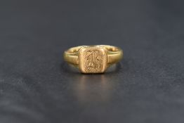 An 18ct gold signet ring, the square panel having 'B' initial engraved with decorative shoulders,