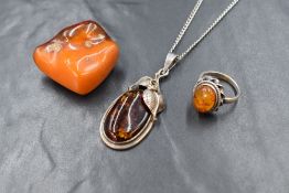 Three pieces of Baltic amber jewellery including a silver ring with oval amber cabochon, a oval