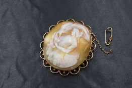 A large 15ct gold mounted cameo brooch, the shell cameo depicting Hebe goddess of youth feeding