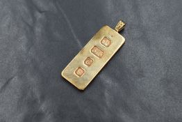 A 9ct gold ingot pendant, the bar marked with London 1977 hallmarks and 375, on a pendant loop,