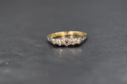 An 18ct gold and platinum diamond chip set five stone ring, the graduated illusion set diamond chips