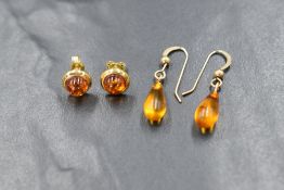 A pair of 9ct gold amber stud earrings, of circular form having a gold surround, marked 375 along
