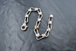 A Tiffany & Co silver heart padlock link bracelet with central yellow metal heart and lobster clasp,