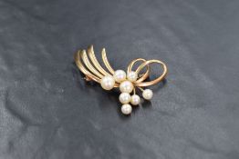 A 9ct gold pearl set spray brooch, the eight cultured pearls in a floral motif design within a