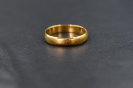 A 22ct gold band, of rounded plain form, marked 22 with hallmarks, ring size O, 3.5g
