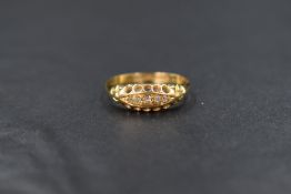 An Edwardian 18ct gold diamond chip set ring, having five small graduated old cut diamonds in a