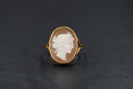 A 22ct gold cameo set ring, the cameo depicting a maiden in profile, in a 22ct gold bezel setting
