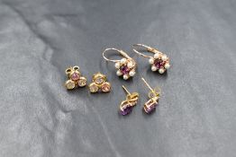 Three pairs of earrings for pierced ears including 9ct gold with amethyst and CZ decoration,