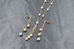 A 9ct gold three tone pebble motif necklace and earring set, the alternating yellow, rose and