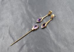 A pair of yellow metal stud earrings with moulded drops having amethyst and diamond chip insets,