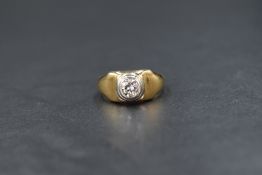 A yellow metal signet ring having an inset diamond of approx 0.5ct in a collared mount to