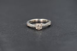 A platinum diamond set solitaire, the central diamond measuring approximately 0.36ct with