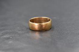 A 9ct gold band, of plain rounded form, marked 375, ring size L-M, 3.6g