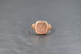 A 9ct rose gold signet ring, the square panel having 'SJL' initials engraved, marked 375, broken